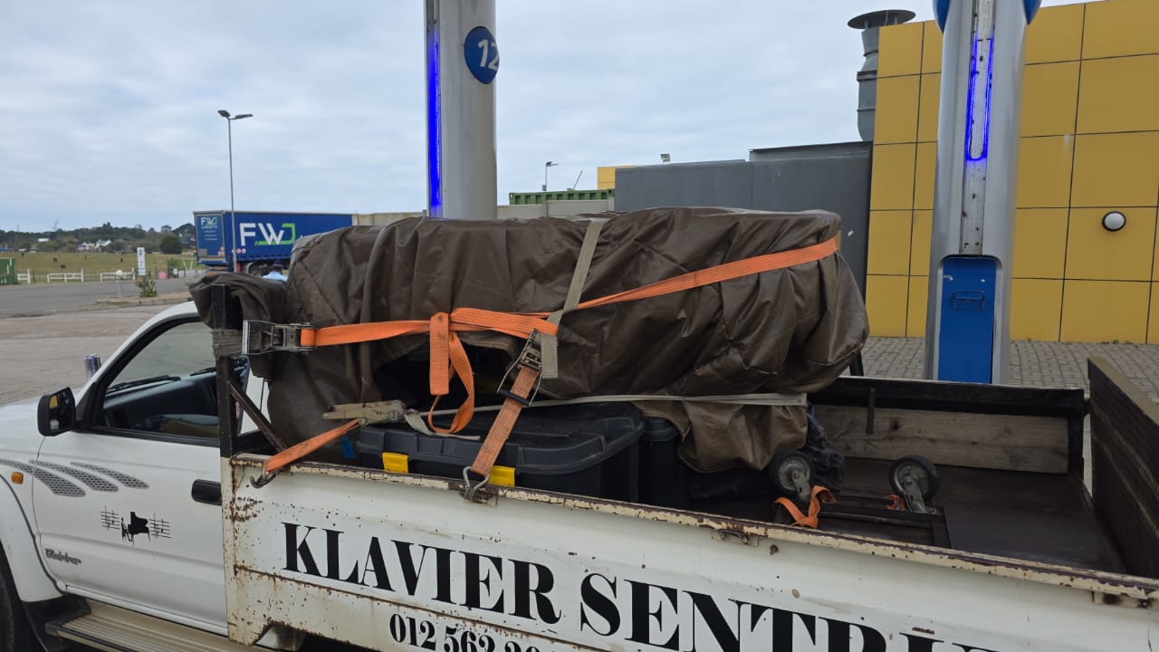 Baby grand piano secured for transport from George to Pretoria