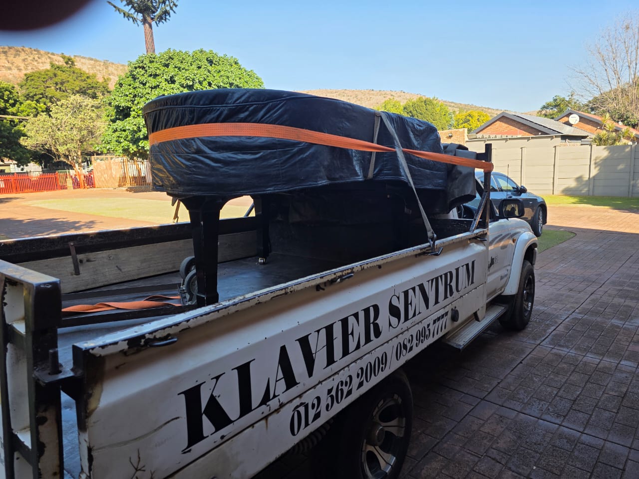 The grand piano secured for transport to the mountain location