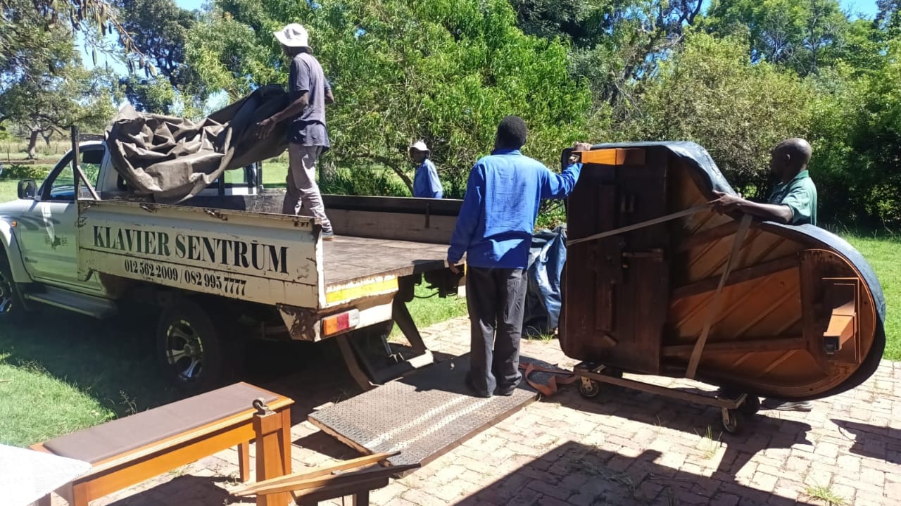 The team loading a piano onto the Klavier Sentrum truck