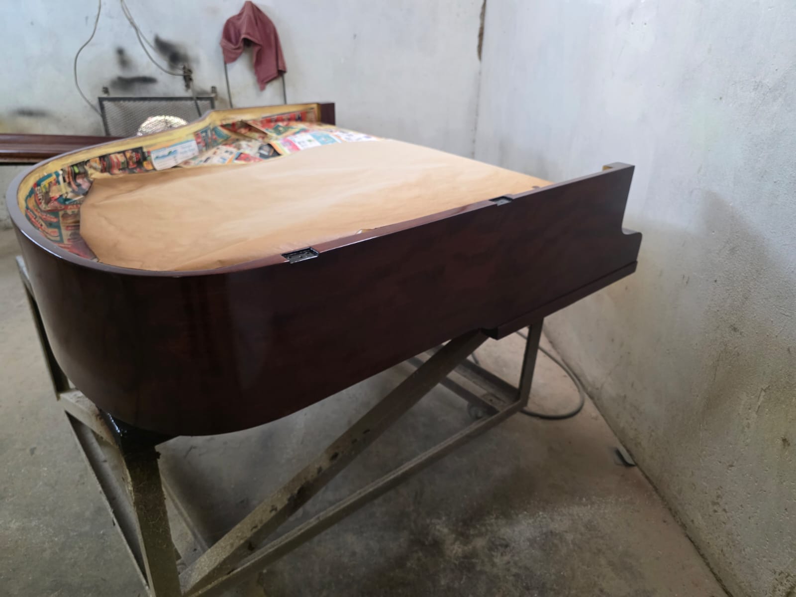 Baby grand piano with closed lid after full cabinet restoration