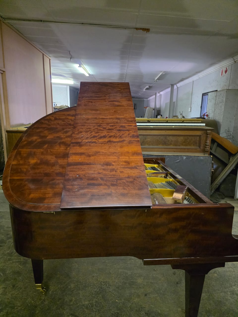 Baby grand piano protected during the final stages of restoration